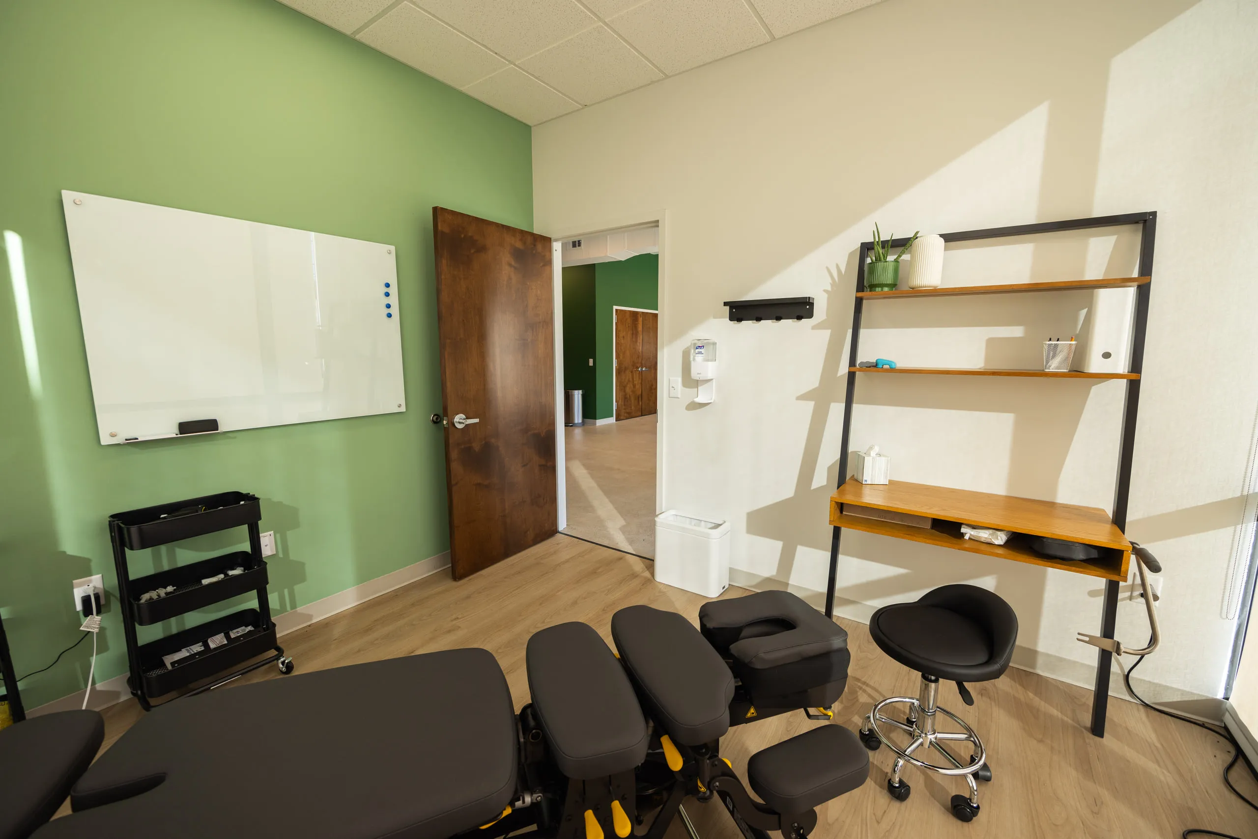 A treatment room at All Square with a whiteboard used to explain findings.