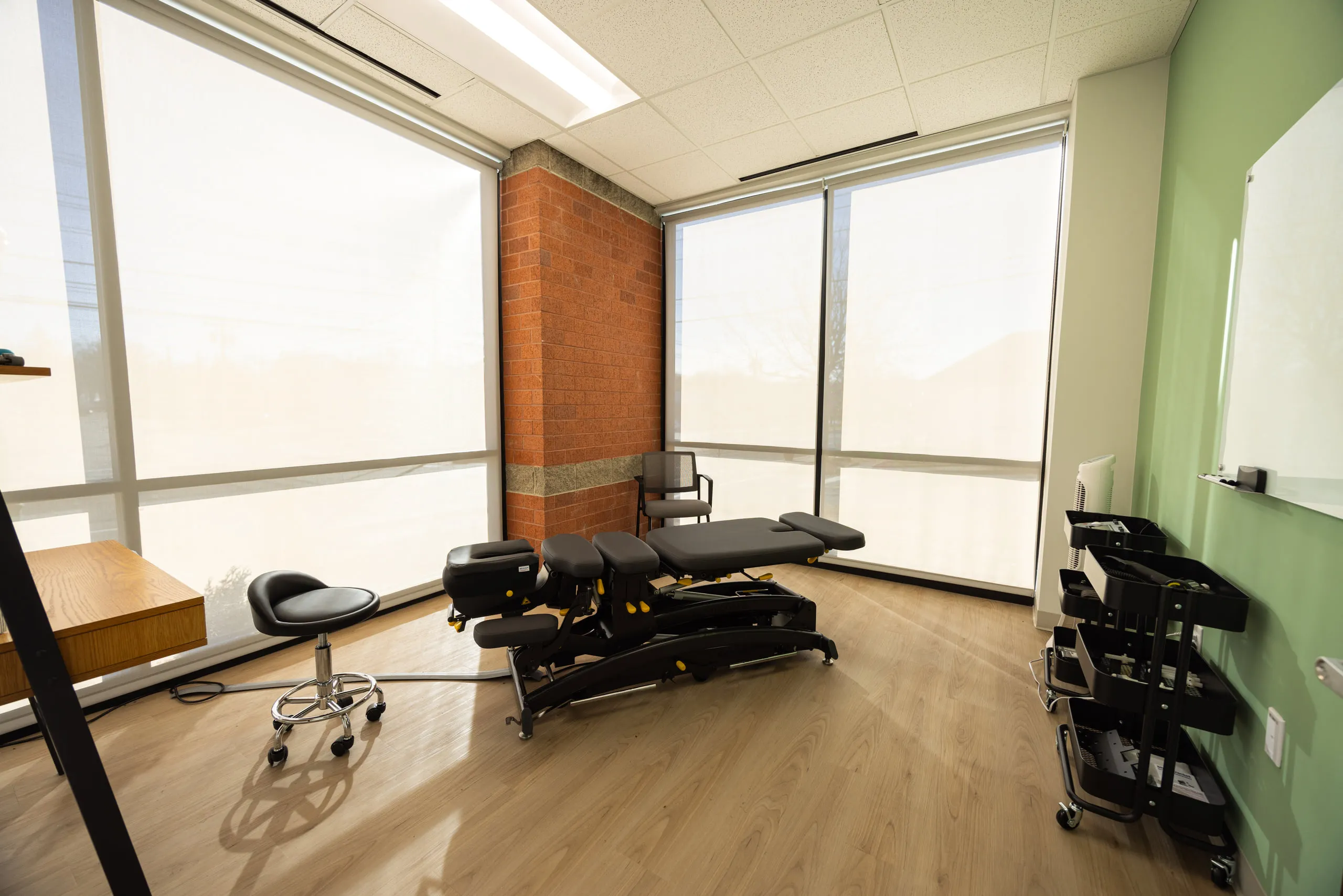 A private treatment room at All Square with a chiropractic table.